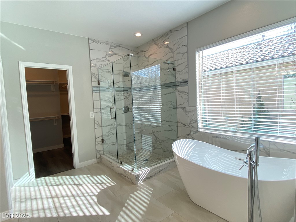 9637 Greensburg Avenue Las Vegas, NV 89178 - Photo 22 of 33 Bathroom featuring a marble finish shower, a walk in closet, a freestanding bath, and recessed lighting