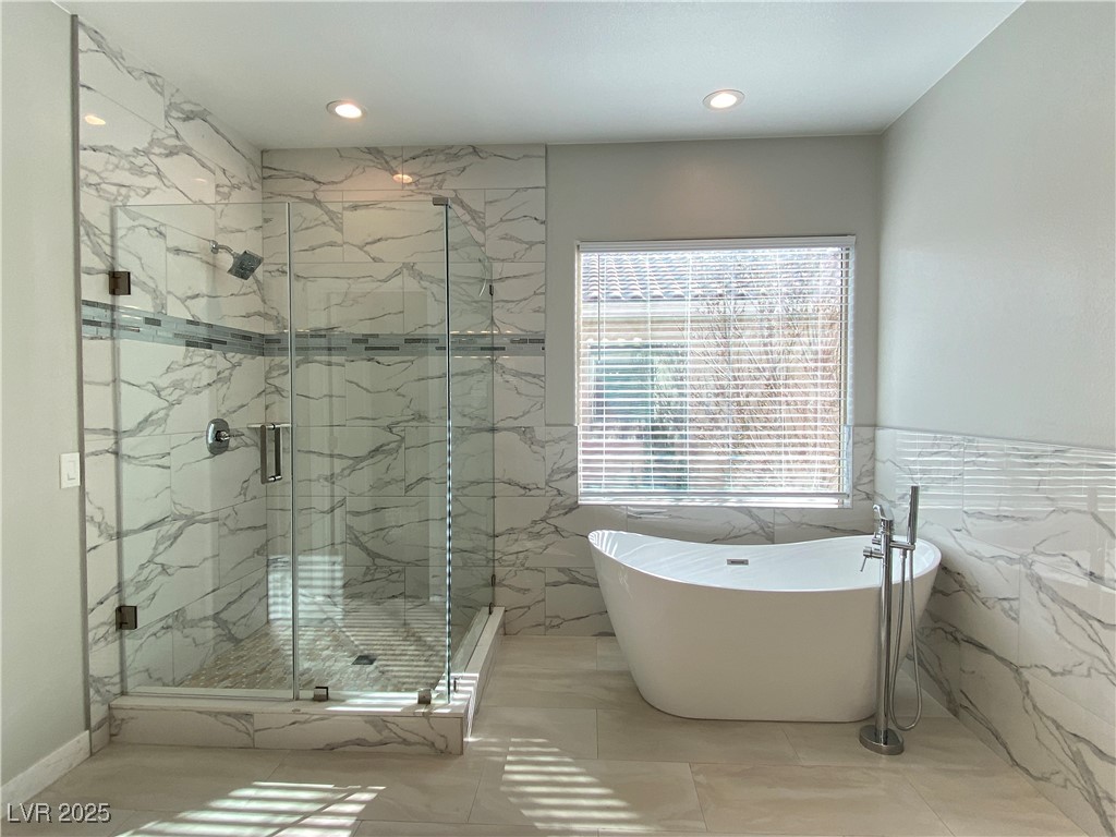 9637 Greensburg Avenue Las Vegas, NV 89178 - Photo 25 of 33 Bathroom with a freestanding bath, a marble finish shower, tile walls, and recessed lighting