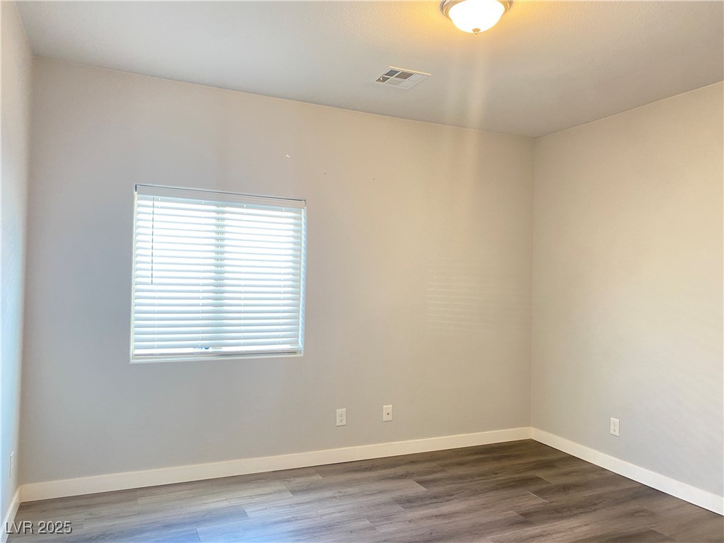 9637 Greensburg Avenue Las Vegas, NV 89178 - Photo 27 of 33 Empty room with wood finished floors, visible vents, and baseboards