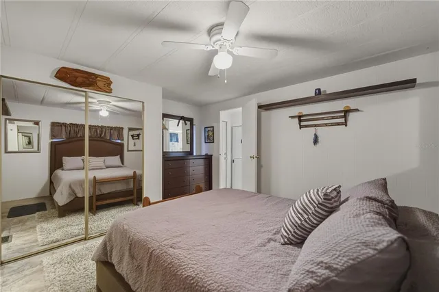 a bedroom with a large bed and a chandelier