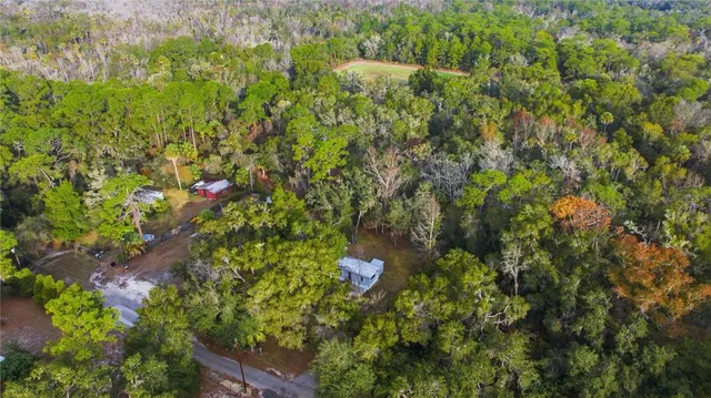 a backyard of a house with lots of green space and trees