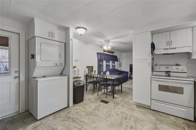 a kitchen with a stove and white cabinets