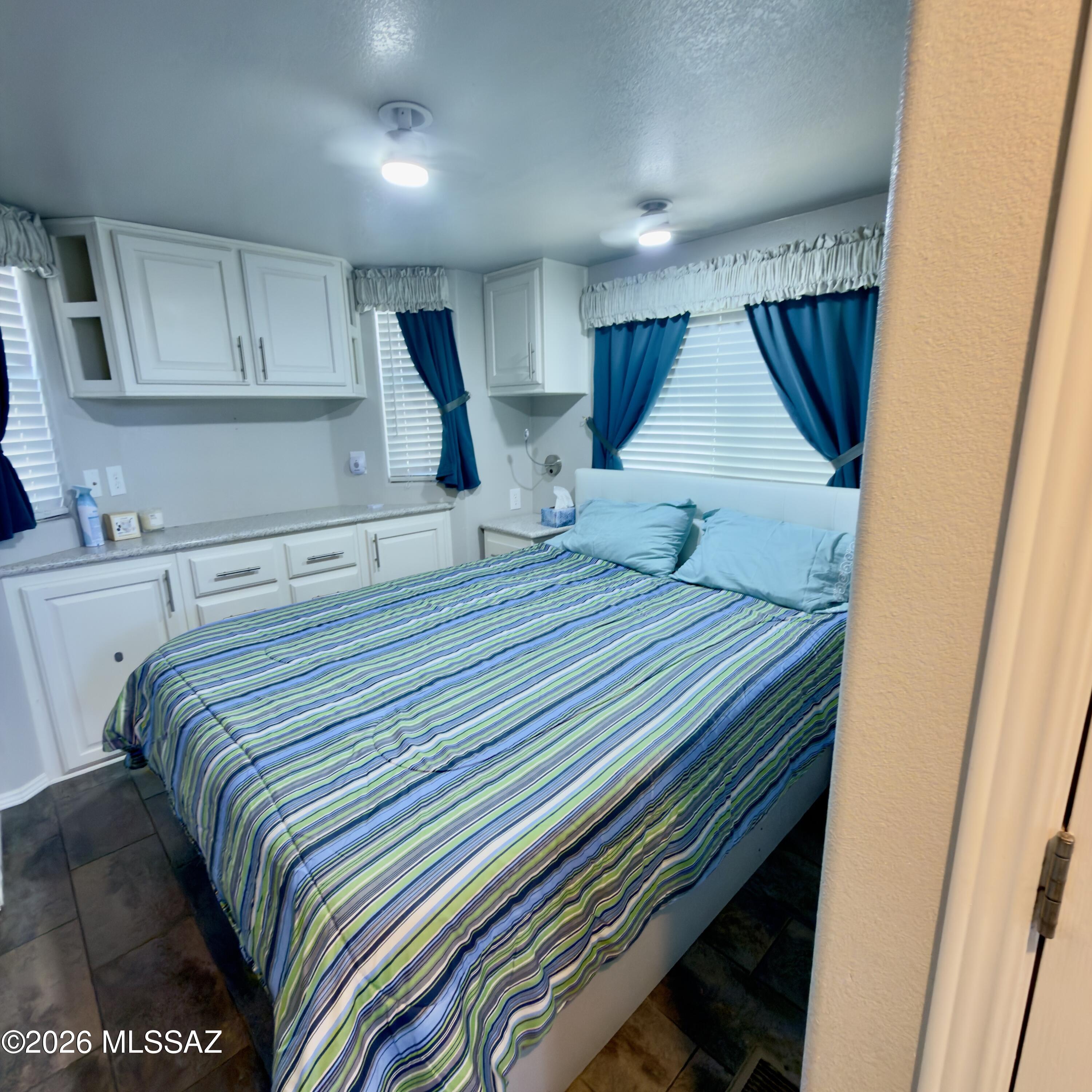 2843 19 Interstate 19 Frontage Road, Unit 116 Amado, AZ 85645 - Photo 12 of 32 a bedroom with a bed and a dresser