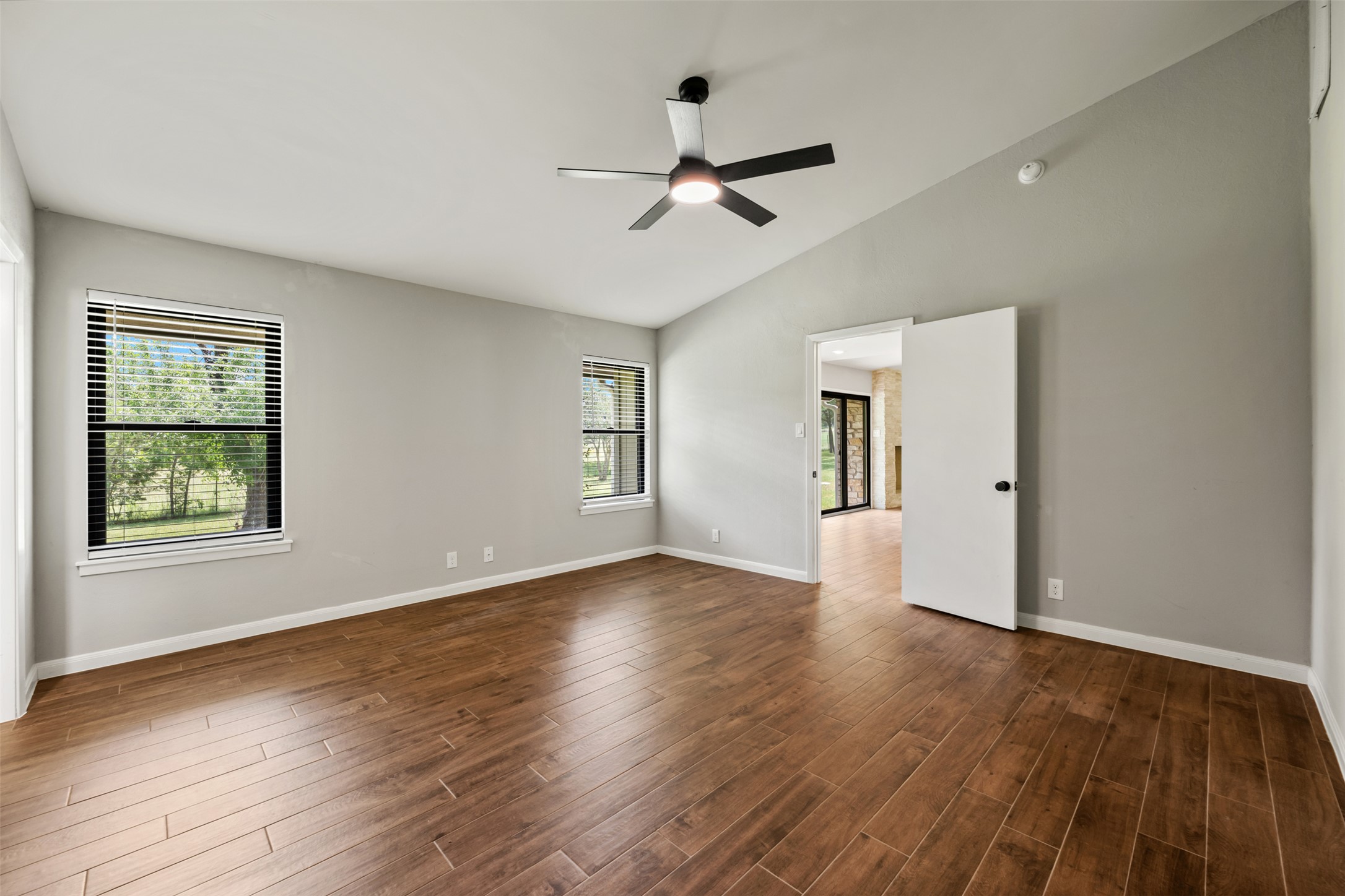 1600 Pin Oak Lane Round Rock, TX 78681 - Photo 24 of 40 Spacious room featuring wood-finish flooring, vaulted ceilings, and a modern ceiling fan