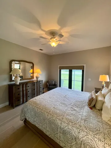 a bedroom with a large bed and a tv