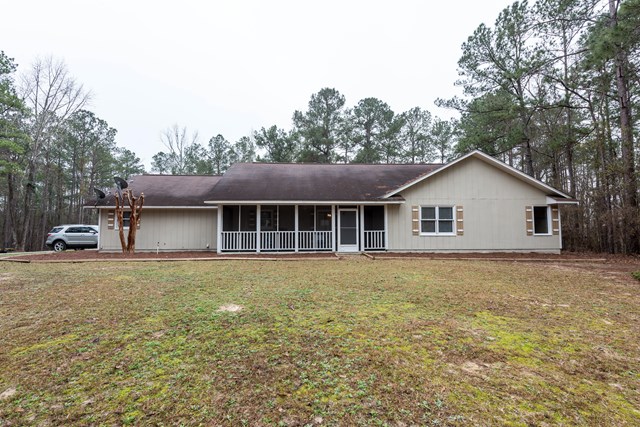 6815 Cartledge Road Box Springs, GA 31801 - Photo 1 of 27 a house with trees in the background