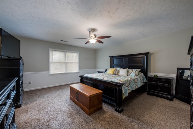 6815 Cartledge Road Box Springs, GA 31801 - Photo 11 of 27 a bed sitting in a bedroom next to a window