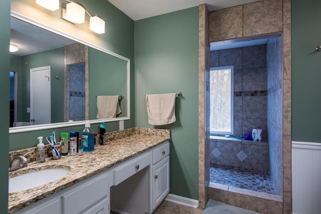 6815 Cartledge Road Box Springs, GA 31801 - Photo 13 of 27 a bathroom with a granite countertop sink and a mirror
