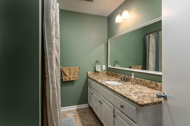 6815 Cartledge Road Box Springs, GA 31801 - Photo 18 of 27 a bathroom with a granite countertop sink and a mirror