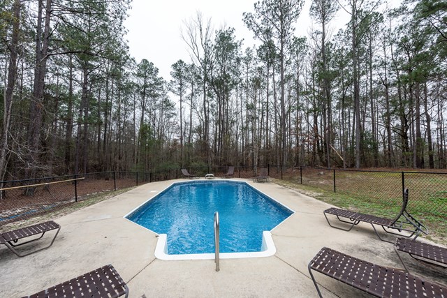 6815 Cartledge Road Box Springs, GA 31801 - Photo 21 of 27 a swimming pool with wooden fence