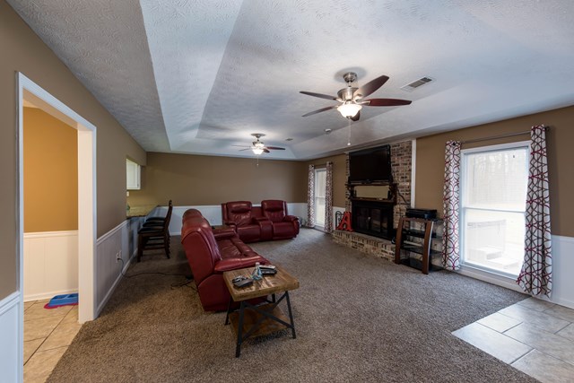 6815 Cartledge Road Box Springs, GA 31801 - Photo 6 of 27 a living room with furniture a ceiling fan and a window