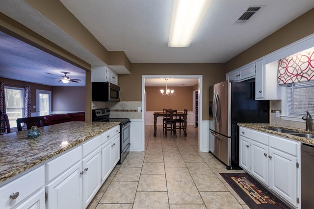 6815 Cartledge Road Box Springs, GA 31801 - Photo 7 of 27 a kitchen with stainless steel appliances granite countertop a sink stove and refrigerator
