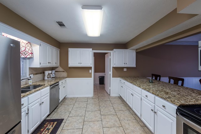 6815 Cartledge Road Box Springs, GA 31801 - Photo 8 of 27 a kitchen with granite countertop a sink a counter top space and cabinets