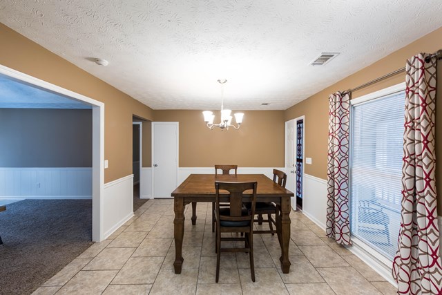 6815 Cartledge Road Box Springs, GA 31801 - Photo 10 of 27 a view of a dining room with furniture and chandelier