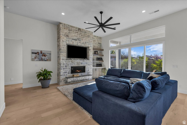 404 North Marsala Way St. George, UT 84770 - Photo 5 of 26 Living room featuring light wood finished floors, ceiling fan, a stone fireplace, and recessed lighting