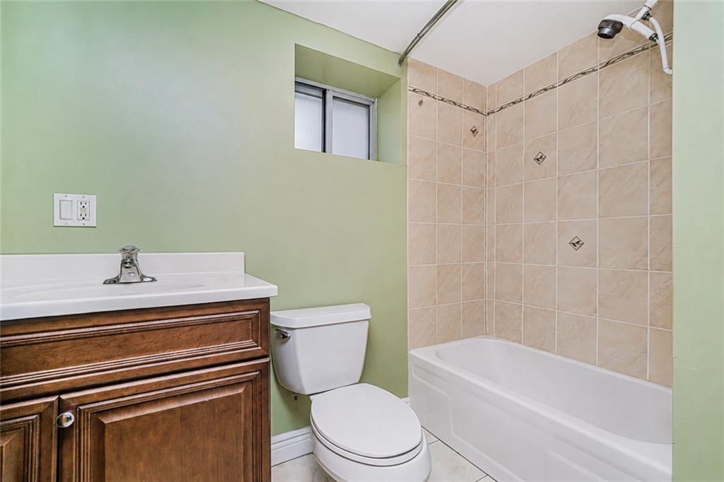 1352 Bay Ridge Parkway Brooklyn, NY 11228 - Photo 35 of 42 a bathroom with a sink a toilet and shower