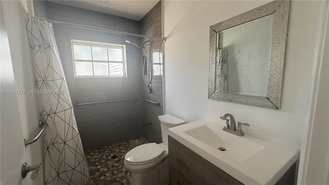 a bathroom with a sink toilet and shower