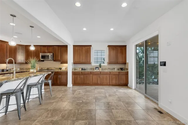 a utility room with granite countertop a sink a washer and dryer