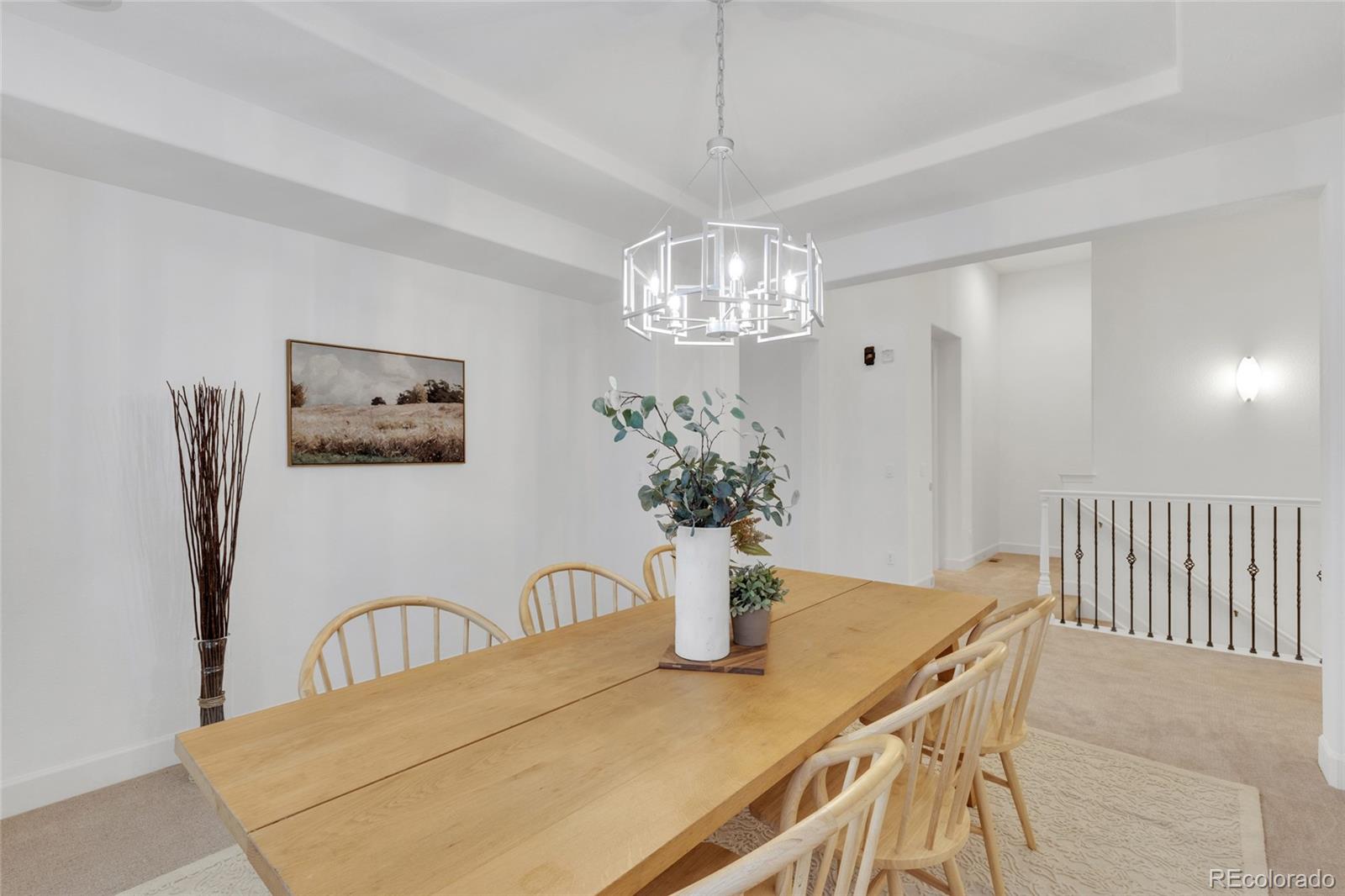 10632 Star Thistle Court Highlands Ranch, CO 80126 - Photo 14 of 50 a view of a dining room with furniture and chandelier