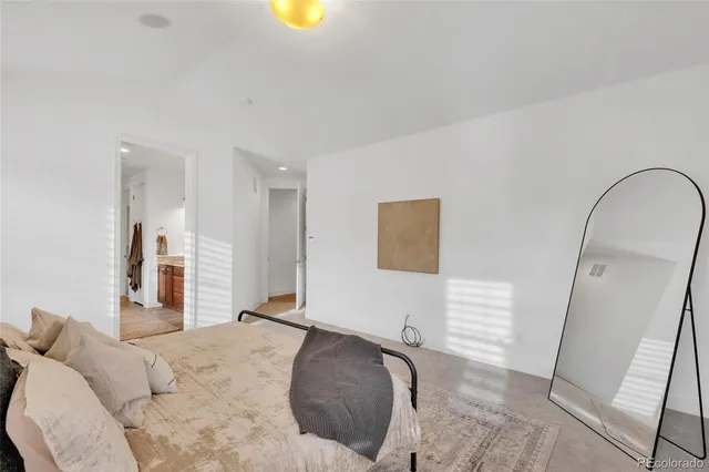 a bathroom with a granite countertop sink a toilet and a mirror