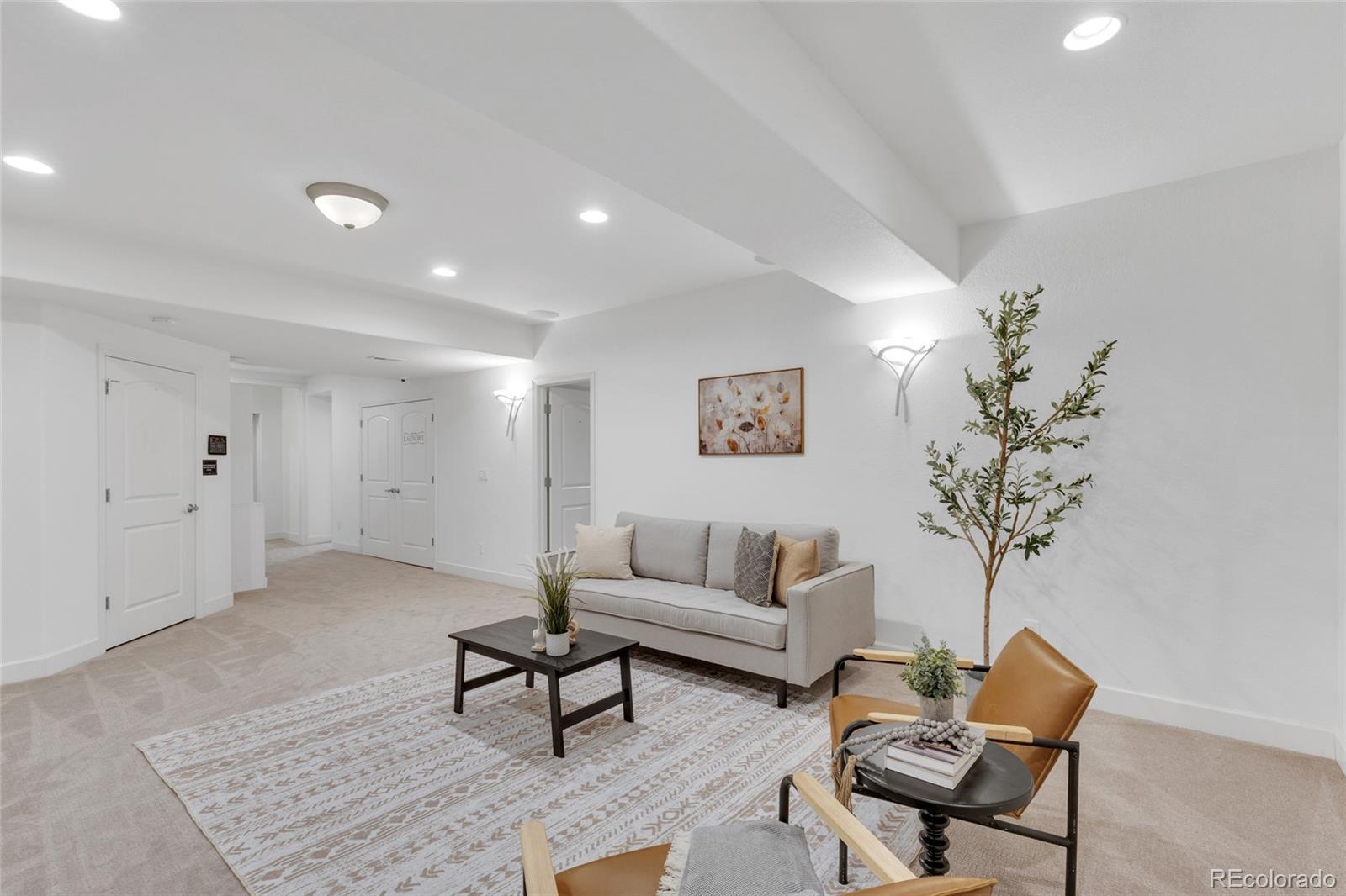 10632 Star Thistle Court Highlands Ranch, CO 80126 - Photo 26 of 50 a living room with furniture and a chandelier