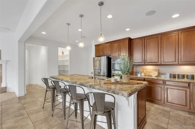 a spacious bathroom with a granite countertop tub a double vanity sink and a large mirror