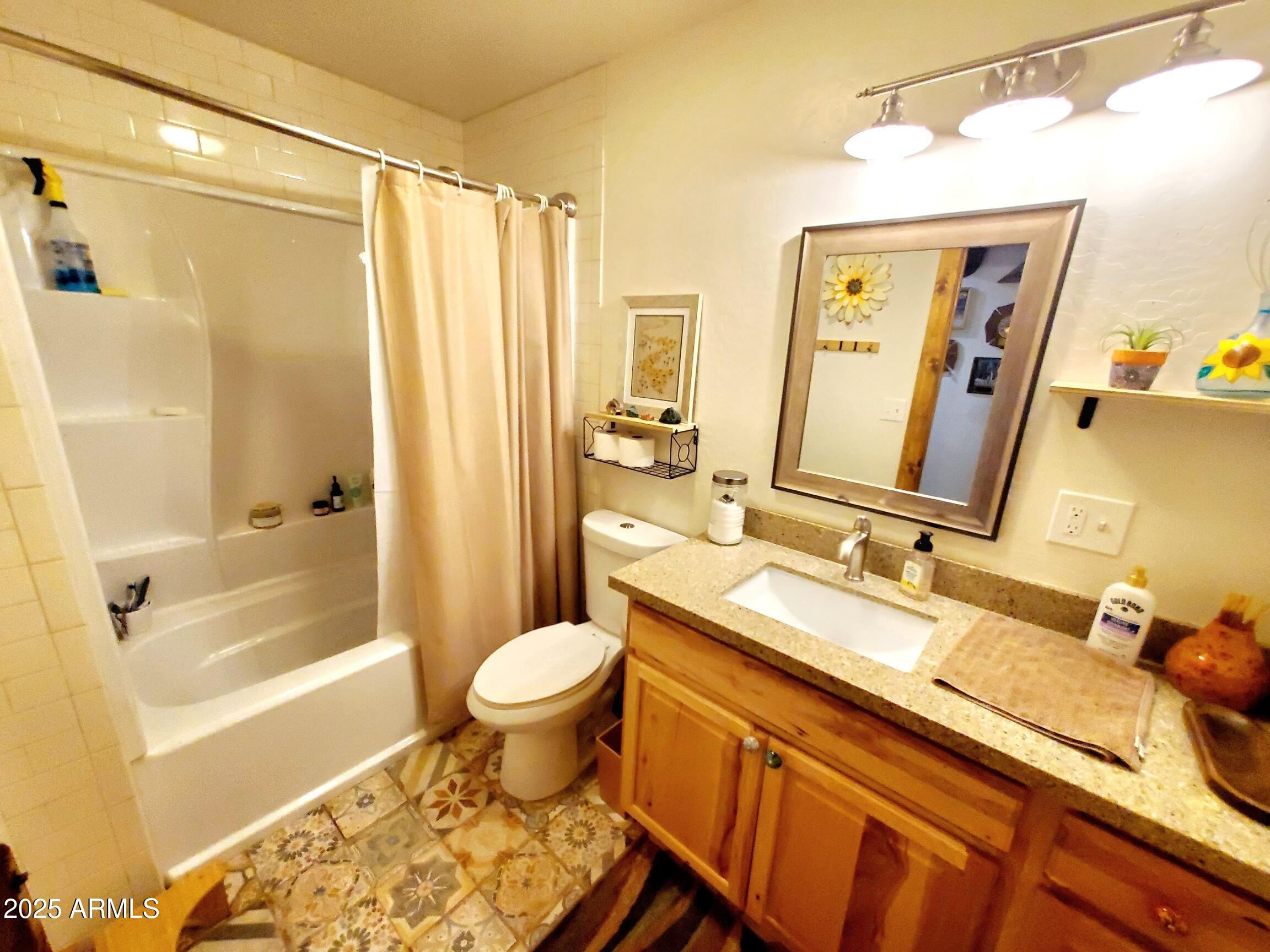 367 River Road Payson, AZ 85541 - Photo 21 of 44 a bathroom with a granite countertop sink toilet and shower
