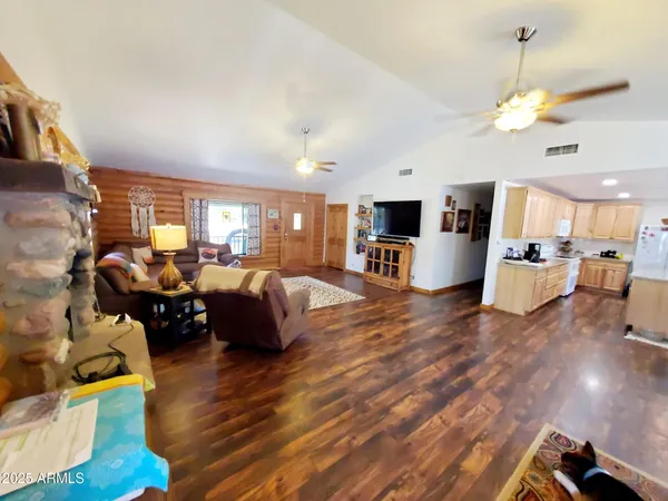 a very nice looking living room with a large window a flat screen tv and outdoor space