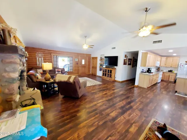 a very nice looking living room with a large window a flat screen tv and outdoor space