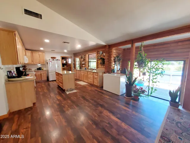 a large kitchen with stainless steel appliances granite countertop a stove and a refrigerator