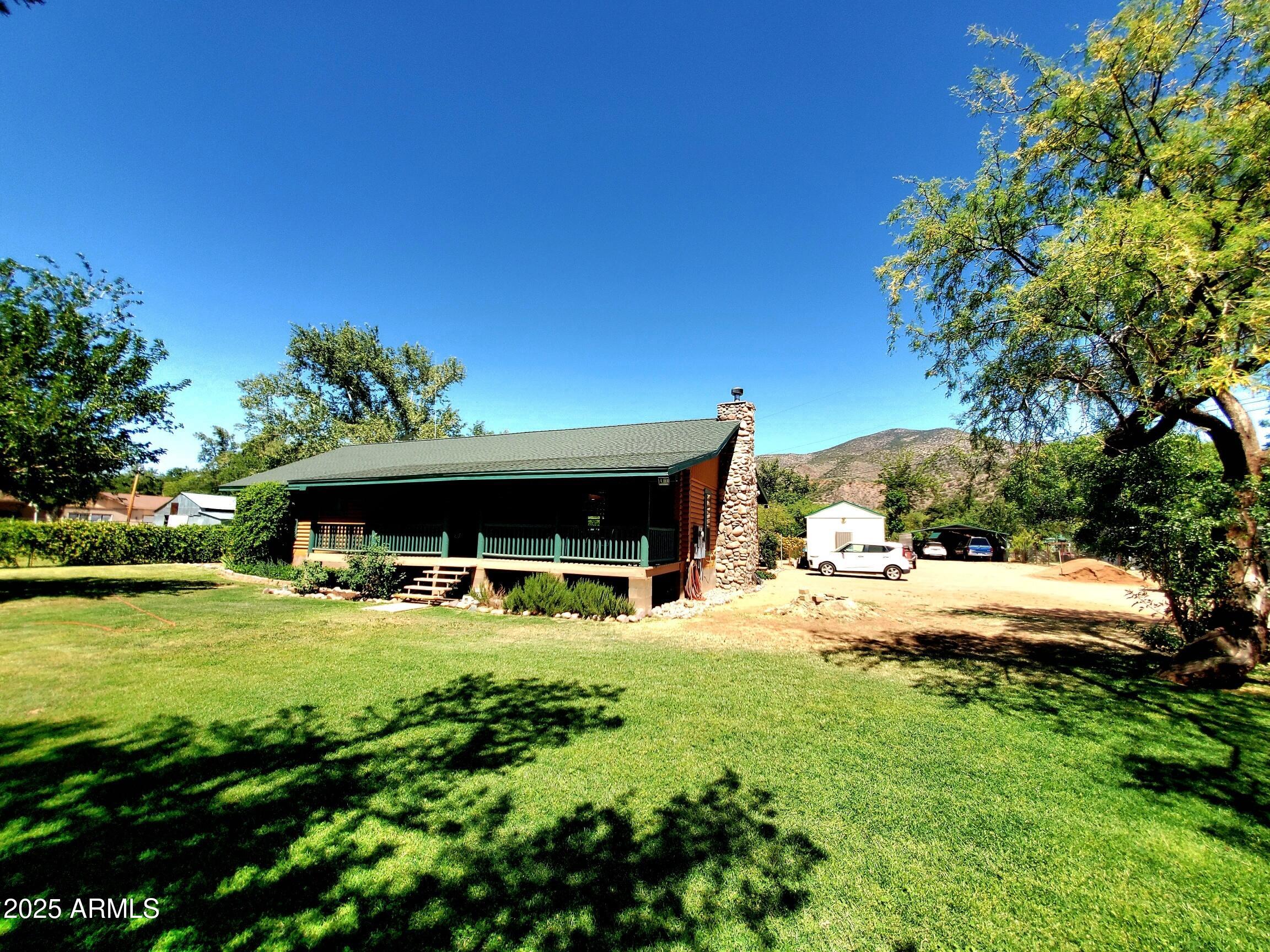 367 River Road Payson, AZ 85541 - Photo 5 of 44 a view of a backyard with table and chairs and potted plants