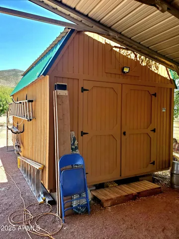 a view of backyard with cabin