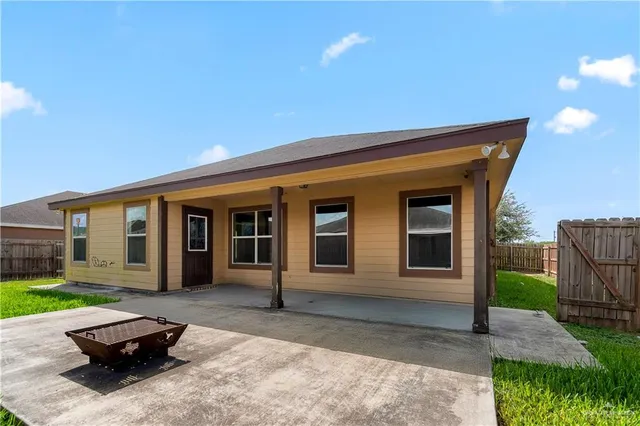 a view of a house with backyard porch and sitting area