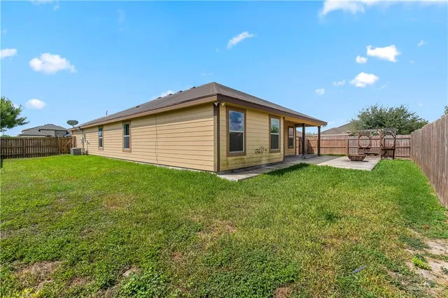 a view of a house with a backyard