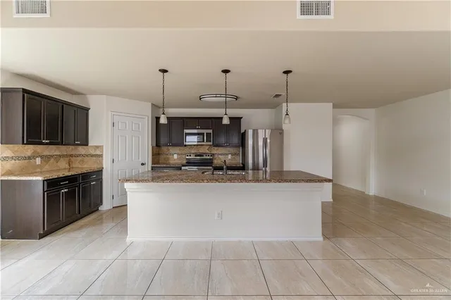 a large kitchen with cabinets and a stove top oven