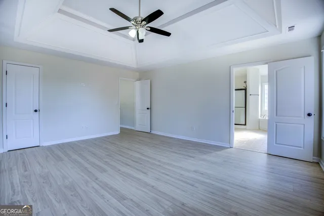 a view of an empty room with wooden floor