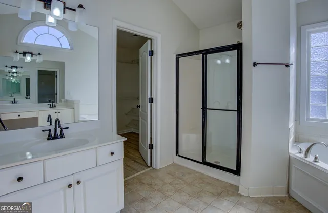 a bathroom with a bathtub and a shower