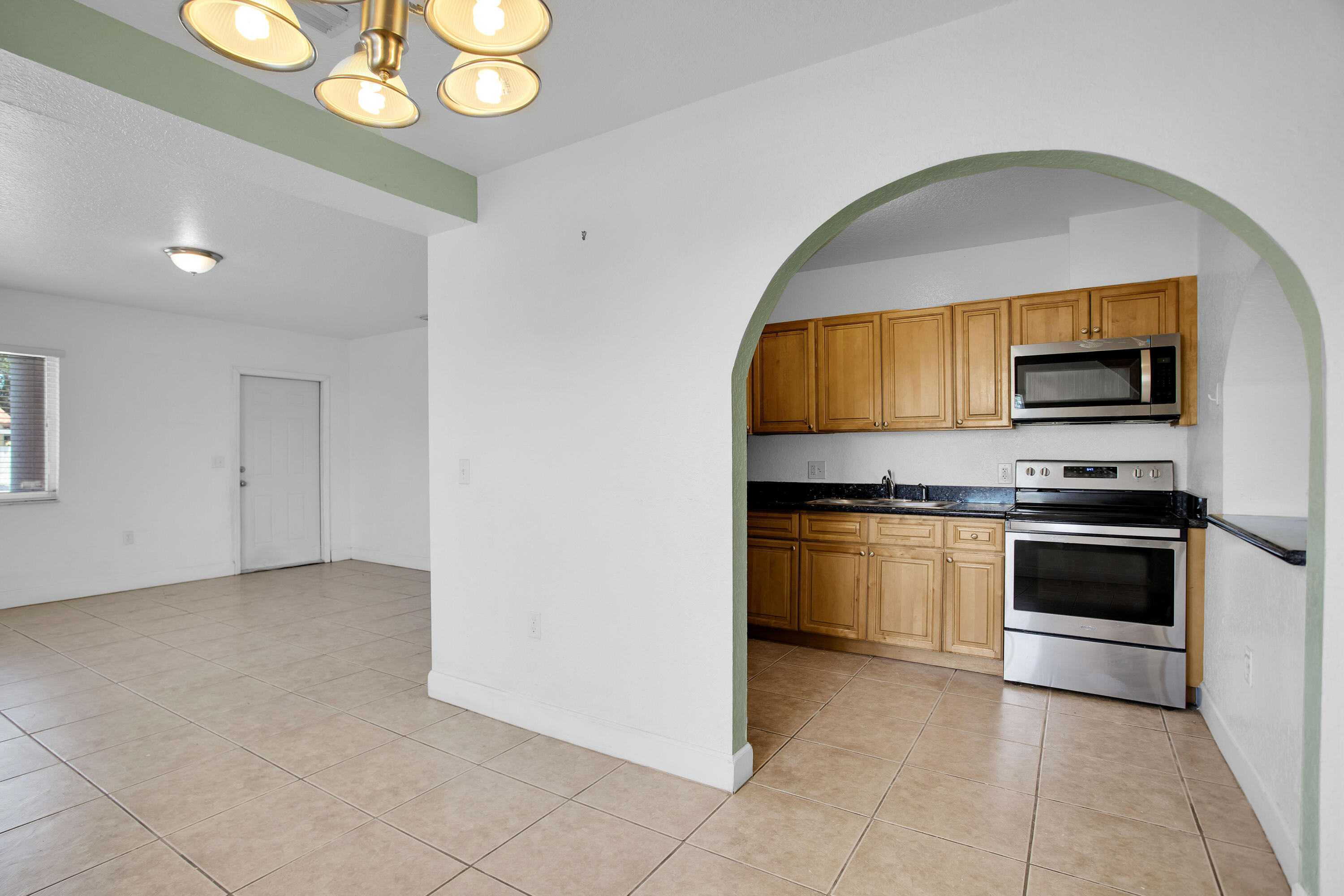 424 Southwest 64th Court Miami, FL 33144 - Photo 11 of 44 a kitchen with stainless steel appliances a stove microwave and a sink