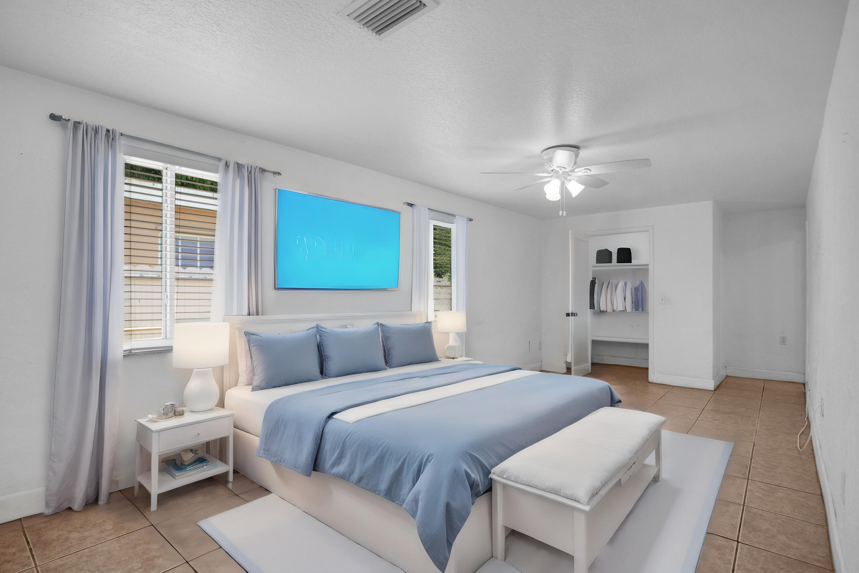 424 Southwest 64th Court Miami, FL 33144 - Photo 27 of 44 a bedroom with a large bed and a chandelier