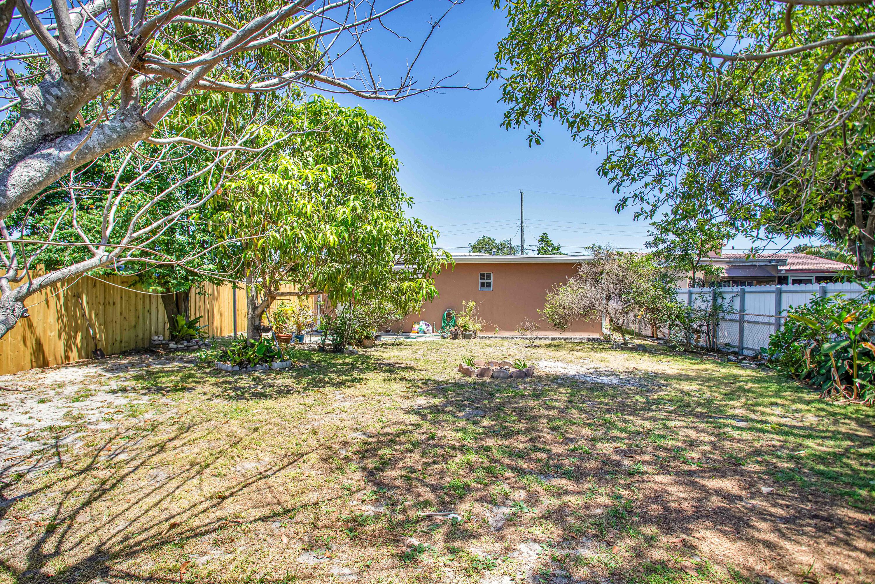 424 Southwest 64th Court Miami, FL 33144 - Photo 41 of 44 a view of a yard with plants and trees