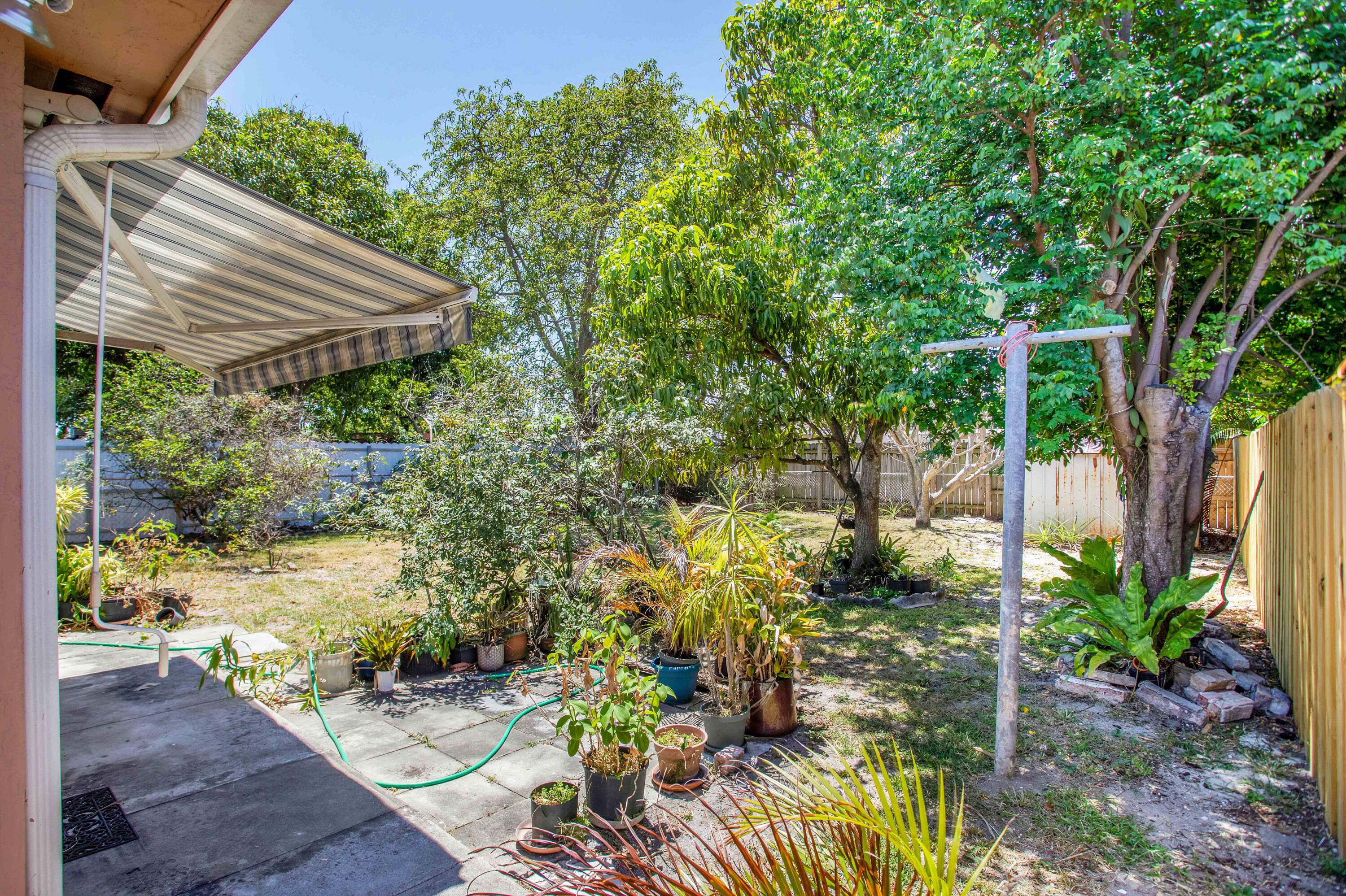 424 Southwest 64th Court Miami, FL 33144 - Photo 43 of 44 a view of a backyard with plants and a garden