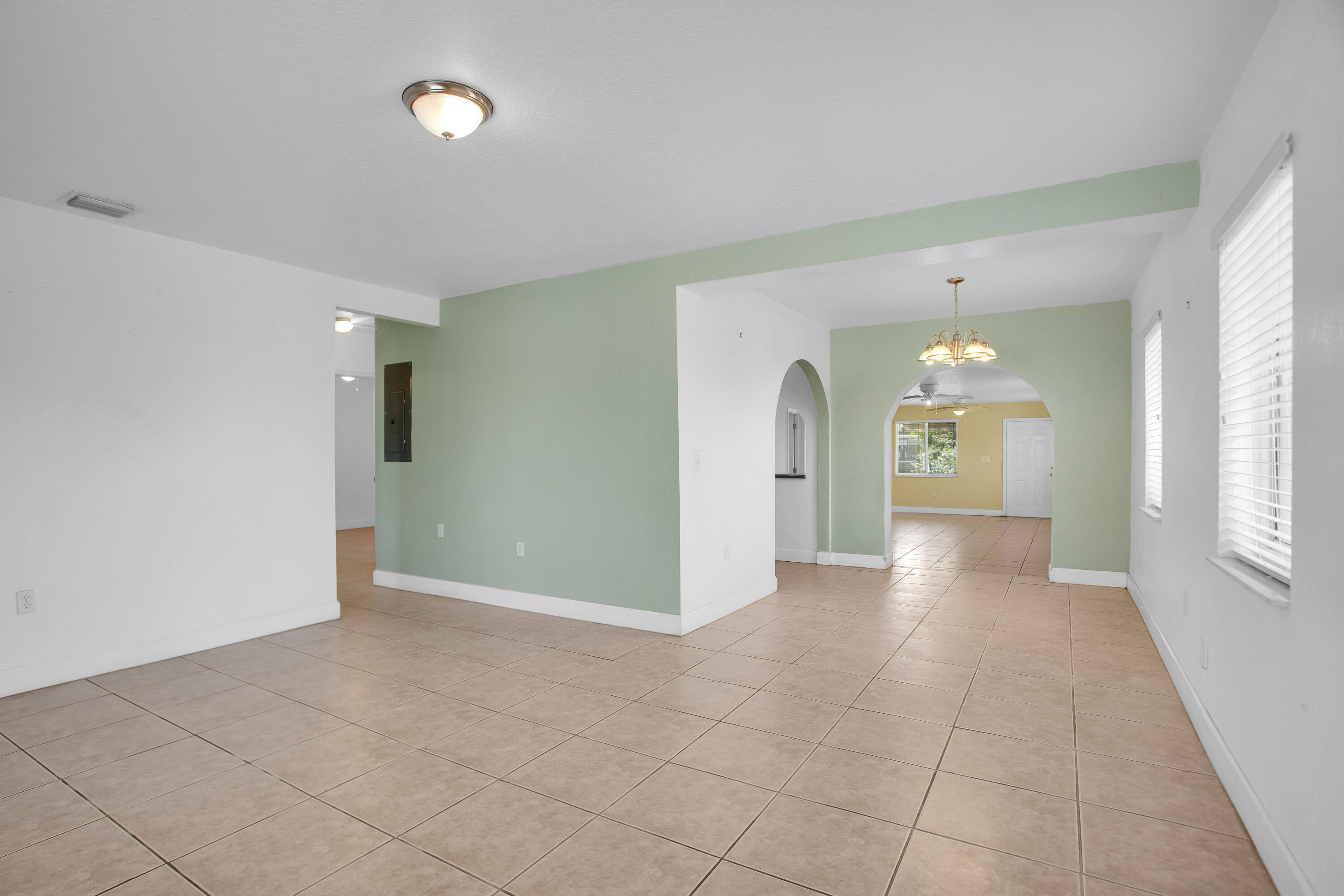 424 Southwest 64th Court Miami, FL 33144 - Photo 10 of 44 wooden floor in a room with a window and a kitchen