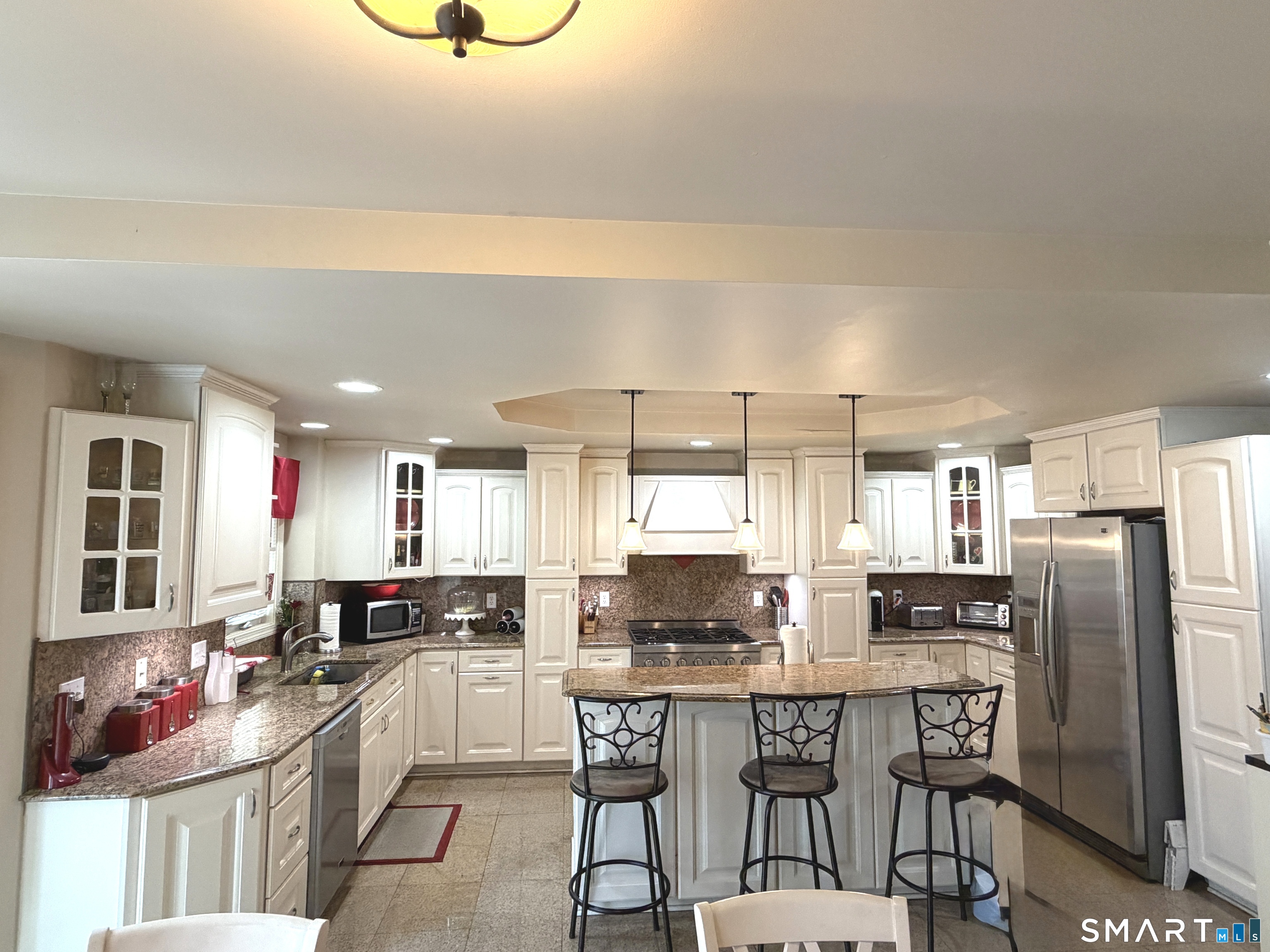 35 Emerald Pines Road Waterbury, CT 06704 - Photo 17 of 40 a kitchen with stainless steel appliances granite countertop a stove top oven a sink dishwasher and cabinets