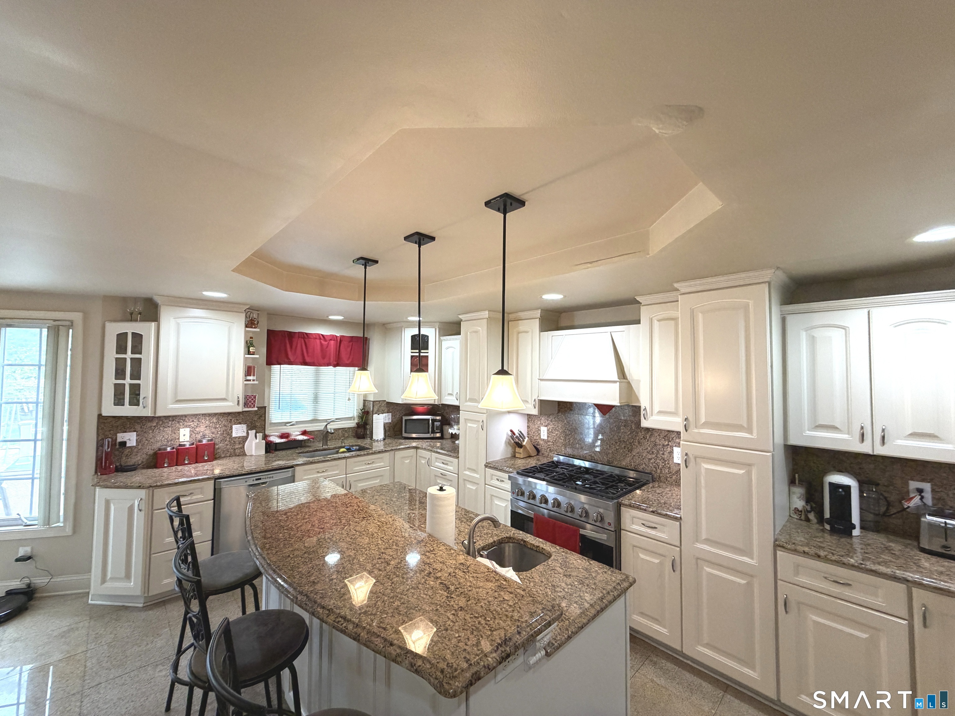 35 Emerald Pines Road Waterbury, CT 06704 - Photo 18 of 40 a kitchen with stainless steel appliances granite countertop a stove top oven a sink dishwasher and cabinets with wooden floor