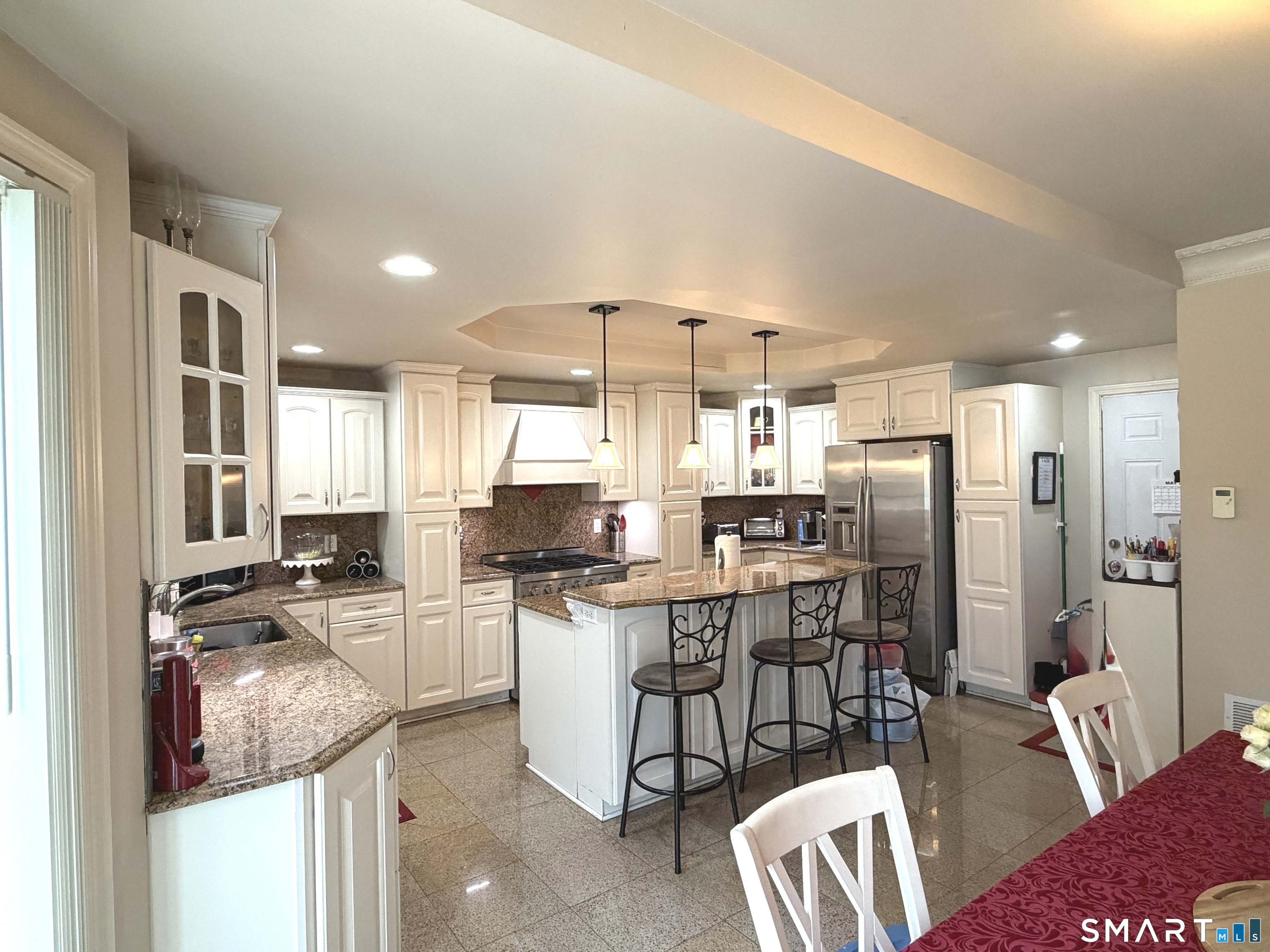 35 Emerald Pines Road Waterbury, CT 06704 - Photo 19 of 40 a kitchen with stainless steel appliances kitchen island granite countertop a refrigerator and a stove top oven