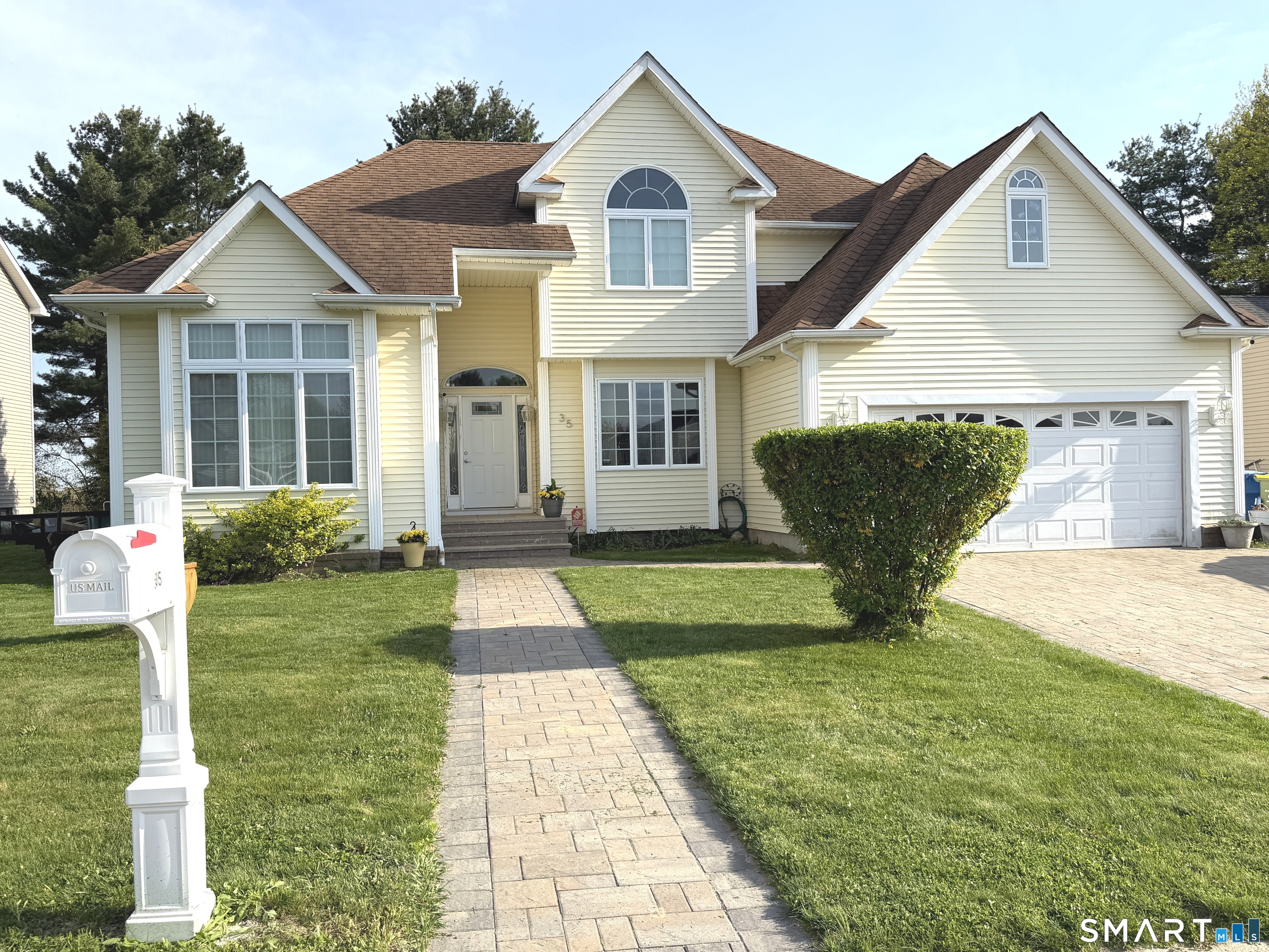 35 Emerald Pines Road Waterbury, CT 06704 - Photo 2 of 40 a front view of a house with garden