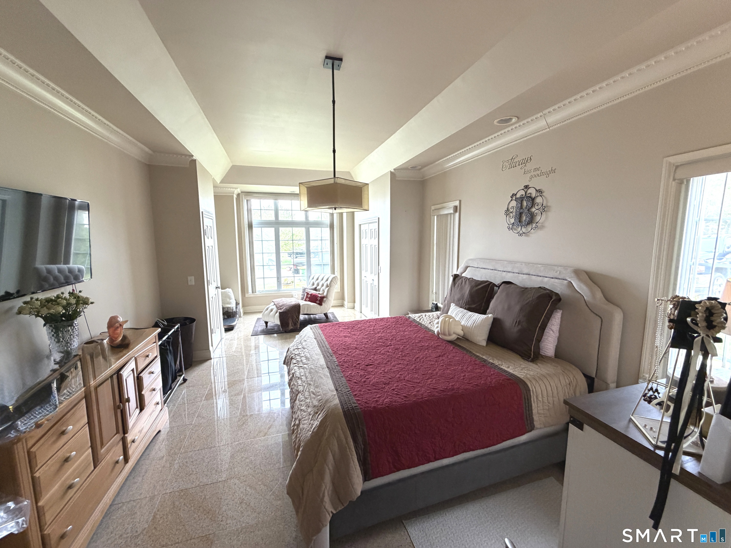 35 Emerald Pines Road Waterbury, CT 06704 - Photo 25 of 40 a spacious bedroom with a bed a couch and a flat tv screen