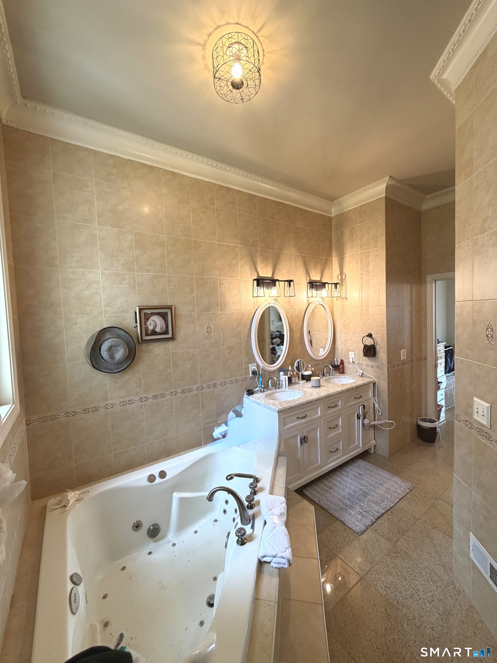 35 Emerald Pines Road Waterbury, CT 06704 - Photo 27 of 40 a bathroom with a sink a mirror and a bathtub