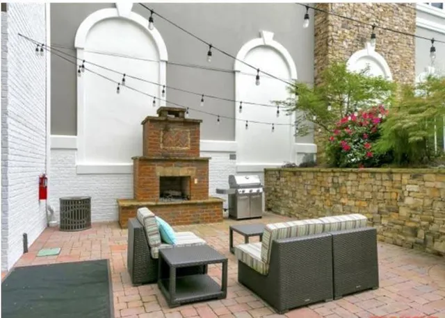 a living room with furniture a fireplace and flowers