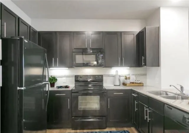 a kitchen with a sink and stainless steel appliances